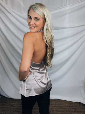 Top features a silky material, halter button closure neck line, sleeveless detail, backless detail, slight cowl neck and runs true to size!-PEARL