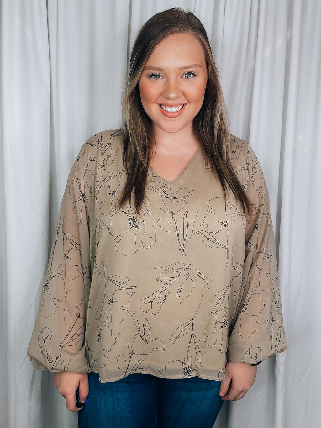 Top features a taupe base, black floral print, underlining, long sleeves, V-neck line, and runs true to size! 