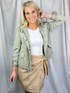 Skirt features solid base color, overlap detail, front tie detail, mini length and runs true to size!-taupe