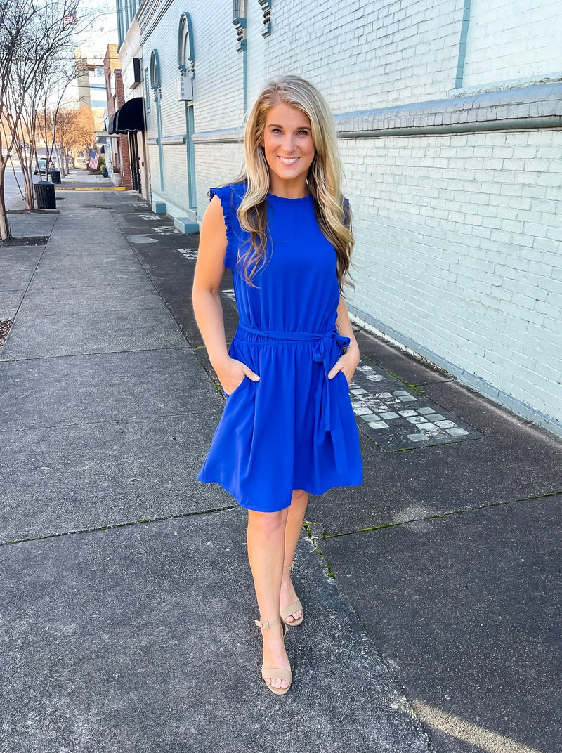 The Everly Dress will have you feeling like a queen in no time! The royal blue color flatters everyone skin tone! Can't you picture yourself looking dashing on a Sunday morning or dinner at the beach?   Dress features a stunning royal blue color, ruffle hem line detail, elastic waist, tie belt addition, functional pockets and runs true to size! 