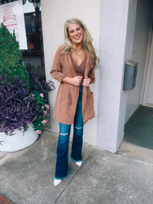 Jacket features a deep colored base, suede material, long sleeves, open front detailing, hood detail, elastic drawstring and runs true to size! -camel