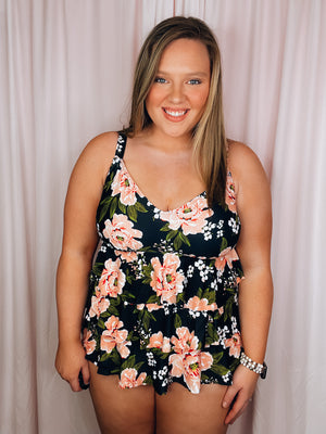Say bon voyage to boring swimwear with this stylish Set Sail One Piece Swimsuit! Featuring a bold black and pink floral print, adjustable straps, and a layered skirted detail, you'll be sure to make waves when you hit the beach. Ready to anchor your style? Then set sail in this flattering and full coverage one piece!