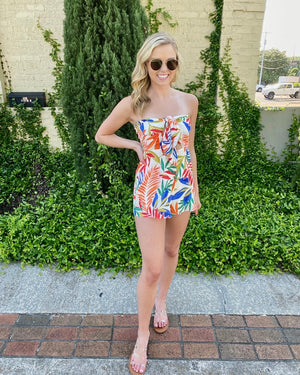 Romper features a red/royal floral print, tube top, front tie detail, and runs true to size! 