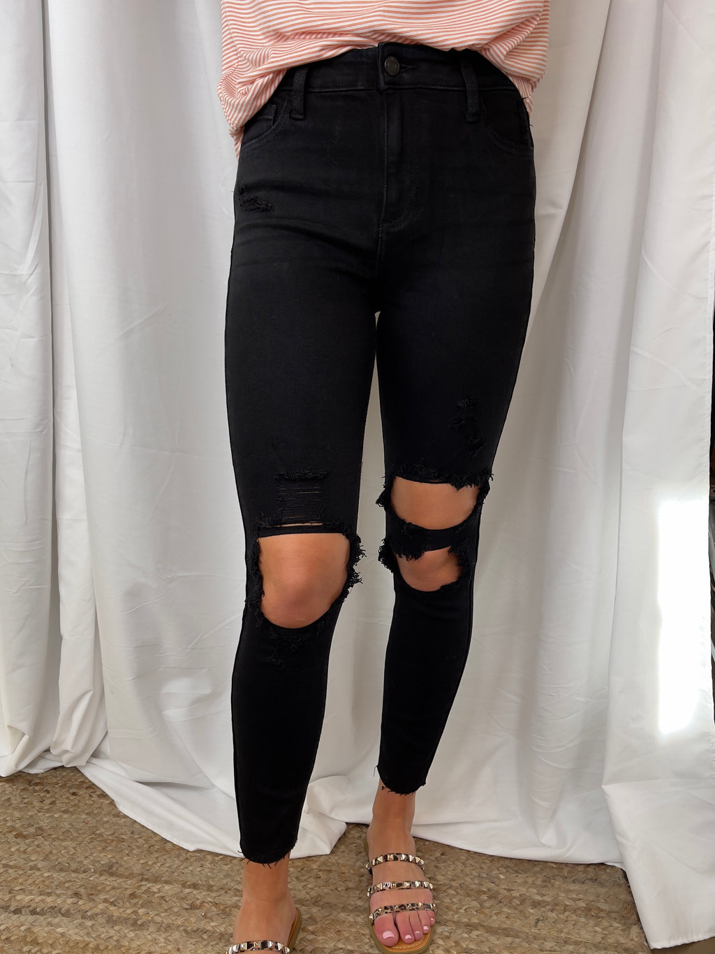 Fitted through the hip and more relaxed through the thigh & knee, our mom skinny jean offers a fit that’s as flattering as it is comfortable. Inspired by the 90s, this jet black wash style with big cutouts along with frayed hem detail gives your look an authentic, vintage vibe.   Inseam: 27"  Rise: 11"