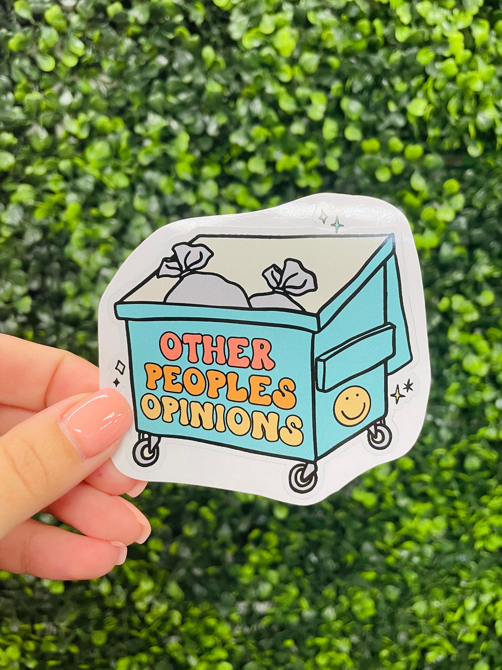 Make a statement with this Trash Other People's Opinions Sticker decal! Featuring a dumpster filled with bubble font, this sticker is perfect for slapping on your water bottle or laptop to let everyone know what you really think. Ditch the drama and show the world what you believe in!