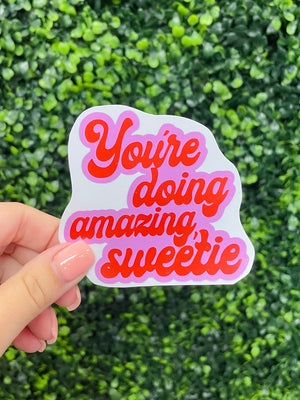 Tell yourself you're doing amazing with this stylish You're Doing Amazing Sweetie sticker! Featuring a vibrant red color and a sweet cursive font, this sticker is perfect for showing love to yourself or someone else. Plus, it's easy to stick on water bottles, laptops, and more! You're doing amazing, sweetie! 💗