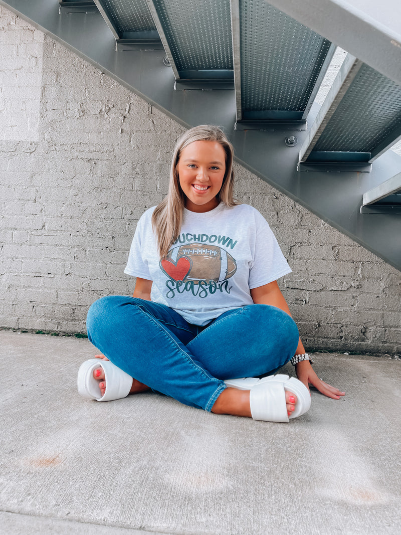 Get ready for touchdown season with this awesome unisex graphic tee! Show your spirit with this classic game day look featuring a football graphic and short sleeves – perfect for any football fanatics out there. TOUCHDOWN!!! 🏈