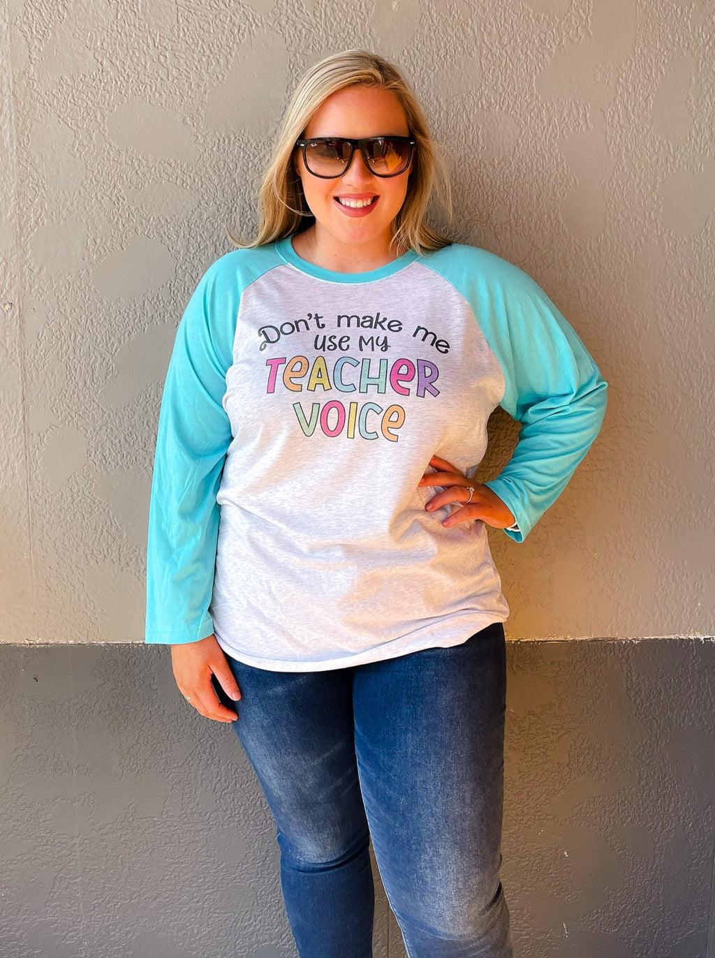 Our Don't Make Me Use My Teacher Voice Raglan is a must-have for all teachers who appreciate a good chuckle! With light blue 3/4 length sleeves and multi-colored font, this unisex fit tee is sure to make your day (or class!) more fun! So don't wait - get your teacher voice raglan now!