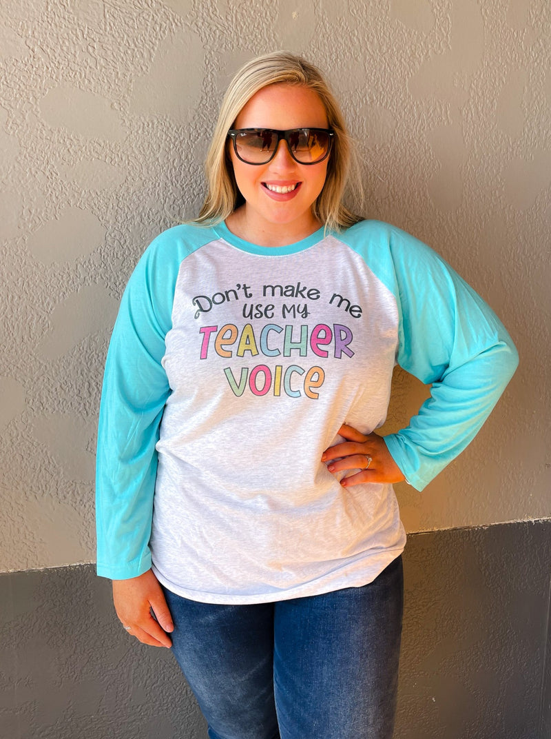 Our Don't Make Me Use My Teacher Voice Raglan is a must-have for all teachers who appreciate a good chuckle! With light blue 3/4 length sleeves and multi-colored font, this unisex fit tee is sure to make your day (or class!) more fun! So don't wait - get your teacher voice raglan now!