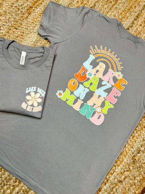 Stay poppin' with the Lake Daze On My Mind Graphic Tee! This summery unisex tee features a "lake daze on my mind" bubble font, sweet flower detailing and bold pastel colors that'll make your wardrobe come alive! Perfect for your next lake outing! Let's get this lake daze party started!