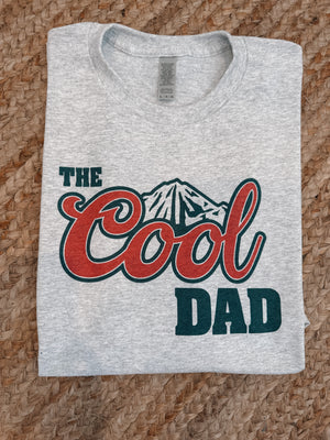 Discover the ultimate 'cool dad' look with The Cool Dad Graphic Tee. It's the perfect tee to show the world you mean business - with style! Crafted from short sleeves, and featuring a distinctive 'cool dad' graphic. This unisex tee is bound to become your go-to for any occasion. So, Cool Dad up and grab yours today!