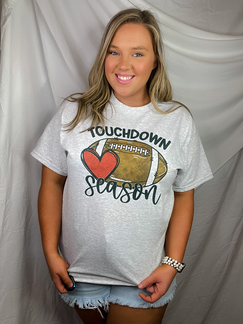 Get ready for touchdown season with this awesome unisex graphic tee! Show your spirit with this classic game day look featuring a football graphic and short sleeves – perfect for any football fanatics out there. TOUCHDOWN!!! 🏈