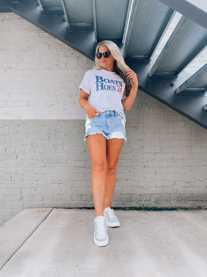 Slip on this quirky Boats & Hoes '24 Graphic Tee and you'll be styling like a real Step Brother! Made with iconic short sleeves, a unisex fit, and round neck line, this graphic tee will have you outfitted for any occasion, nautical themed or not! Ahoy!