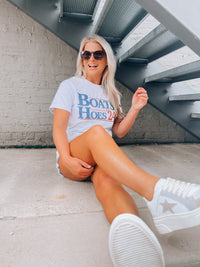 Slip on this quirky Boats & Hoes '24 Graphic Tee and you'll be styling like a real Step Brother! Made with iconic short sleeves, a unisex fit, and round neck line, this graphic tee will have you outfitted for any occasion, nautical themed or not! Ahoy!