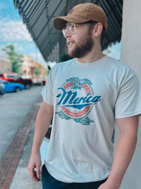 Show your American pride in this Merica Since 1776 graphic tee! Perfect for BBQs, 4th of July, or simply getting together with friends, you'll be the star-spangled sensation in this patriotic fit. Who said fashion and patriotism don't mix?  2XL will be printed on an ash grey instead of a tan color🖤