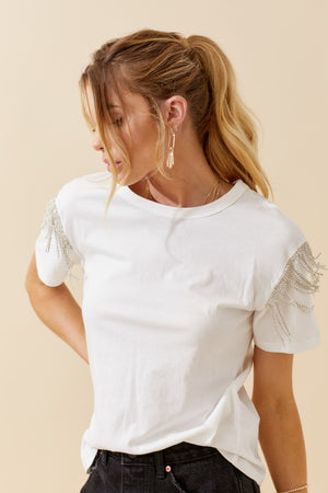 Top features a solid base color, short sleeves, round neck line, rhinestone detailing and runs true to size! -white