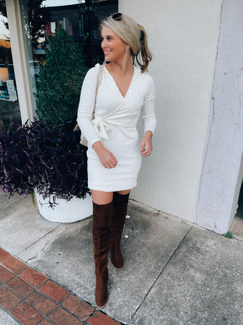 Dress features a solid base color, soft knit material, long sleeves, V-neck line, tie waist band, knee length and runs true to size with a true fitted shape!-ivory