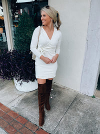 Dress features a solid base color, soft knit material, long sleeves, V-neck line, tie waist band, knee length and runs true to size with a true fitted shape!-ivory