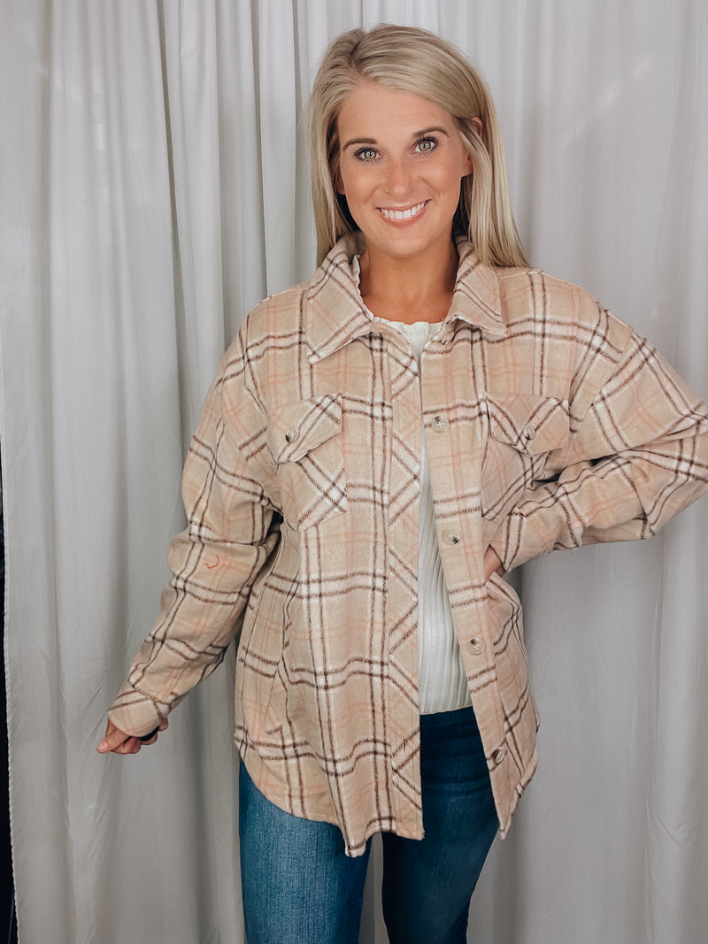 Shacket features a tan/ brown plaid print, long sleeves, open front detailing, button closure and runs true to size! 