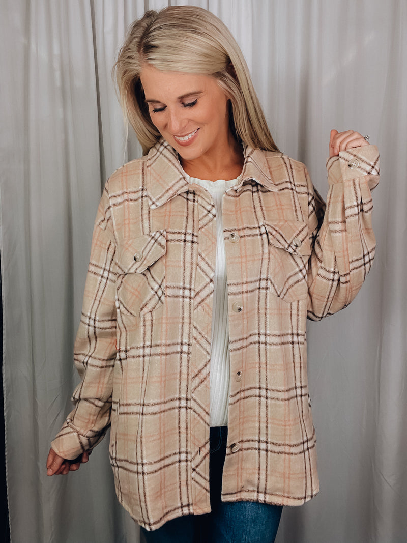 Shacket features a tan/ brown plaid print, long sleeves, open front detailing, button closure and runs true to size! 