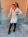 Dress features a solid base color, soft knit material, long sleeves, V-neck line, tie waist band, knee length and runs true to size with a true fitted shape!-ivory