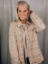 Shacket features a tan/ brown plaid print, long sleeves, open front detailing, button closure and runs true to size! 