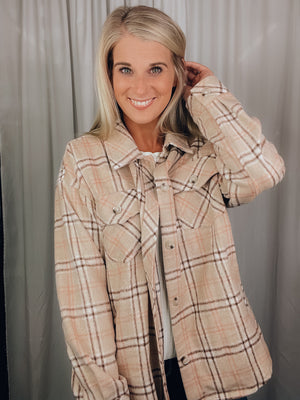 Shacket features a tan/ brown plaid print, long sleeves, open front detailing, button closure and runs true to size! 