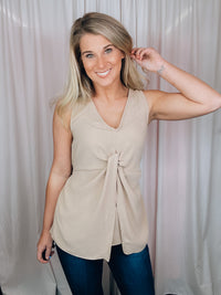 This versatile top is a perfect statement piece for all seasons. Crafted with an elegant taupe color, the Subtly Sweet Top features a sleeveless design, a round neckline, layered detailing and a front twist knot detail. Its neutral color complements any outfit and is sure to add a stylish touch to your wardrobe.  Top features a neutral beige color, sleeveless detail, round neck line, twist knot detail, layered look and runs true to size! 