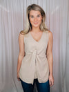 This versatile top is a perfect statement piece for all seasons. Crafted with an elegant taupe color, the Subtly Sweet Top features a sleeveless design, a round neckline, layered detailing and a front twist knot detail. Its neutral color complements any outfit and is sure to add a stylish touch to your wardrobe.  Top features a neutral beige color, sleeveless detail, round neck line, twist knot detail, layered look and runs true to size! 