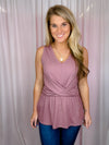 This top is crafted from ribbed mauve fabric, featuring an eye-catching front twist knot and a flattering V-neck. With its sleeveless design, you can enjoy the perfect style balance between comfort and fashion.