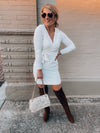 Dress features a solid base color, soft knit material, long sleeves, V-neck line, tie waist band, knee length and runs true to size with a true fitted shape!-ivory