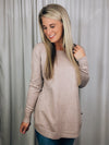 Top features a deep taupe color, dreamy soft material, long sleeves, boat neck line, hi-low hem and runs true to size! 