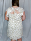 Dress features an ivory base, taupe abstract print, short ruffle sleeves, tie back detail and runs true to size! 