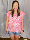 Top features a pink floral print, short ruffle sleeves, V-neck line and runs true to size! 