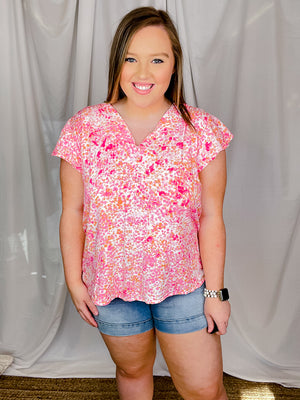 Top features a pink floral print, short ruffle sleeves, V-neck line and runs true to size! 