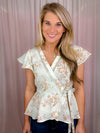 Our Flirty Darling Top showcases a mint base adorned with a beautiful floral print, featuring short sleeves and a V-neck line. The waist is cinched for a flattering fit, and tie detail adds a romantic touch. Make a statement with this elegant and feminine piece.