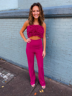 Jumpsuit features a stunning magenta color, mush ruffle top, open stomach detail, bell bottom pants, zipper back detail and runs true to size! 