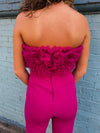 Jumpsuit features a stunning magenta color, mush ruffle top, open stomach detail, bell bottom pants, zipper back detail and runs true to size! 