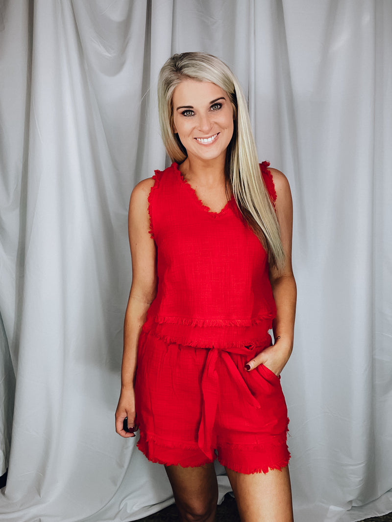 Set offers a solid base color, sleeveless detail, tank and short pieces, frayed lining detail, pockets, tie belt, with a textured look to add the perfect amount of detail. Runs true to size!-RED