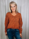 Sweater features a solid base color, long sleeves, V-neck line and runs true to size!-rust