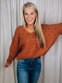 Sweater features a solid base color, long sleeves, V-neck line and runs true to size!-rust