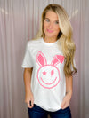 This Smile Face Bunny Tee is the perfect addition to your wardrobe. With its smile face, lighting bolt eyes, bunny ears, short sleeves, and round neck line, this unisex fit shirt will add a cheerful touch to your summer look. Best of all, it's comfortable and cute for the upcoming holiday! -white