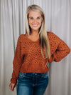 Sweater features a solid base color, long sleeves, V-neck line and runs true to size!-rust