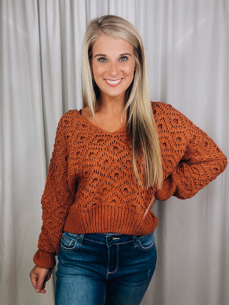 Sweater features a solid base color, long sleeves, V-neck line and runs true to size!-rust