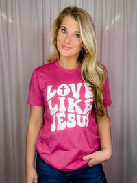 This premium Love Like Jesus Tee is a modern and stylish way to express faith and hope this Easter. Made for a soft and comfortable fit, it features short sleeves, a unisex fit, and a round neck line. With an inspiring "Love Like Jesus" graphic design, it perfectly captures the spirit of the season.-magenta