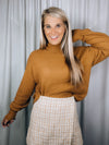 Sweater features a solid base color, long sleeves, round neck line and runs true to size!-camel