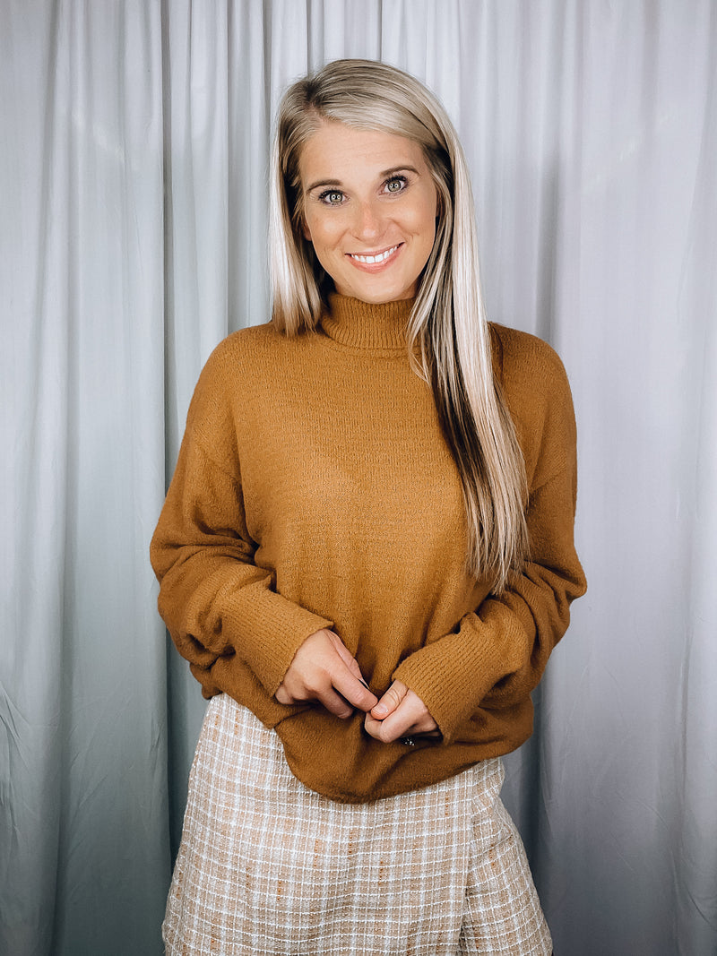 Sweater features a solid base color, long sleeves, round neck line and runs true to size!-camel