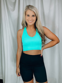 Top features a fitted fit, razor back detail, non padded top, ribbed stretchy material, cropped length and runs true to size!-mint