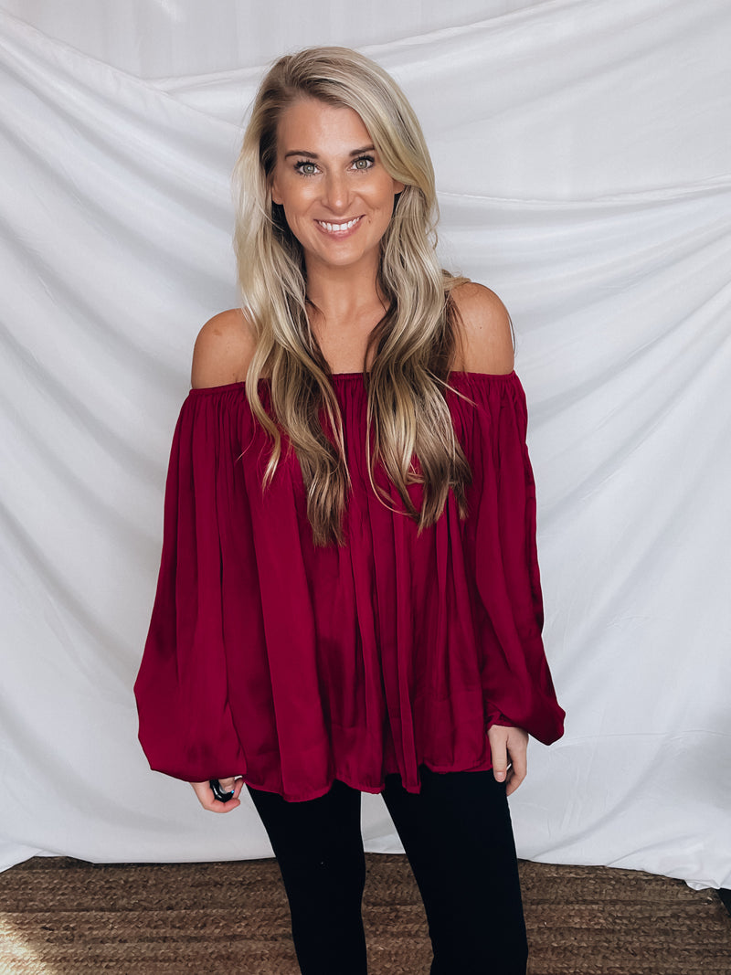 Top features a wine color, peasant sleeves, ruffled detail, elastic waist/ shoulder, loose fit, can be worn on or off the shoulder and runs true to size! 
