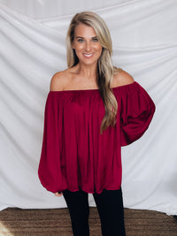 Top features a wine color, peasant sleeves, ruffled detail, elastic waist/ shoulder, loose fit, can be worn on or off the shoulder and runs true to size! 